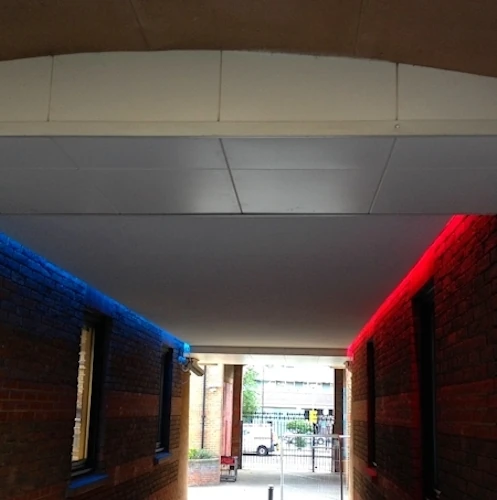 Outdoor suspended ceiling with red and blue LED lighting.